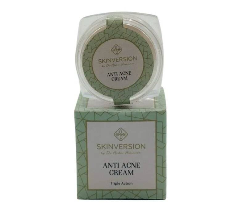 Anti-acne cream in a sleek tube, placed on a clean, white surface with natural ingredients like aloe vera and tea tree leaves around it, symbolizing freshness and skincare benefits